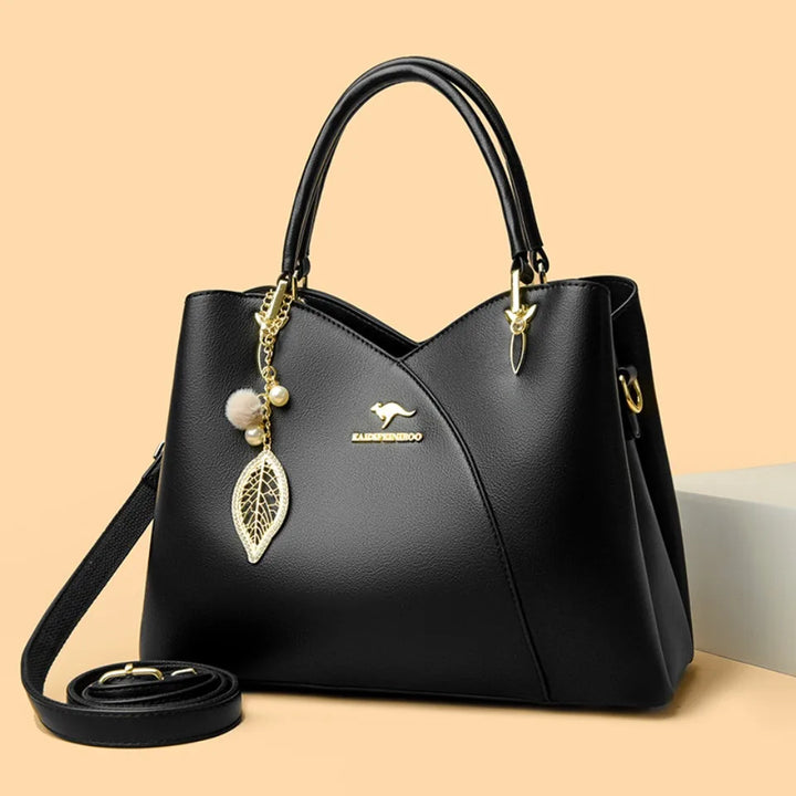 Elegant black shoulder bag with stylish charms